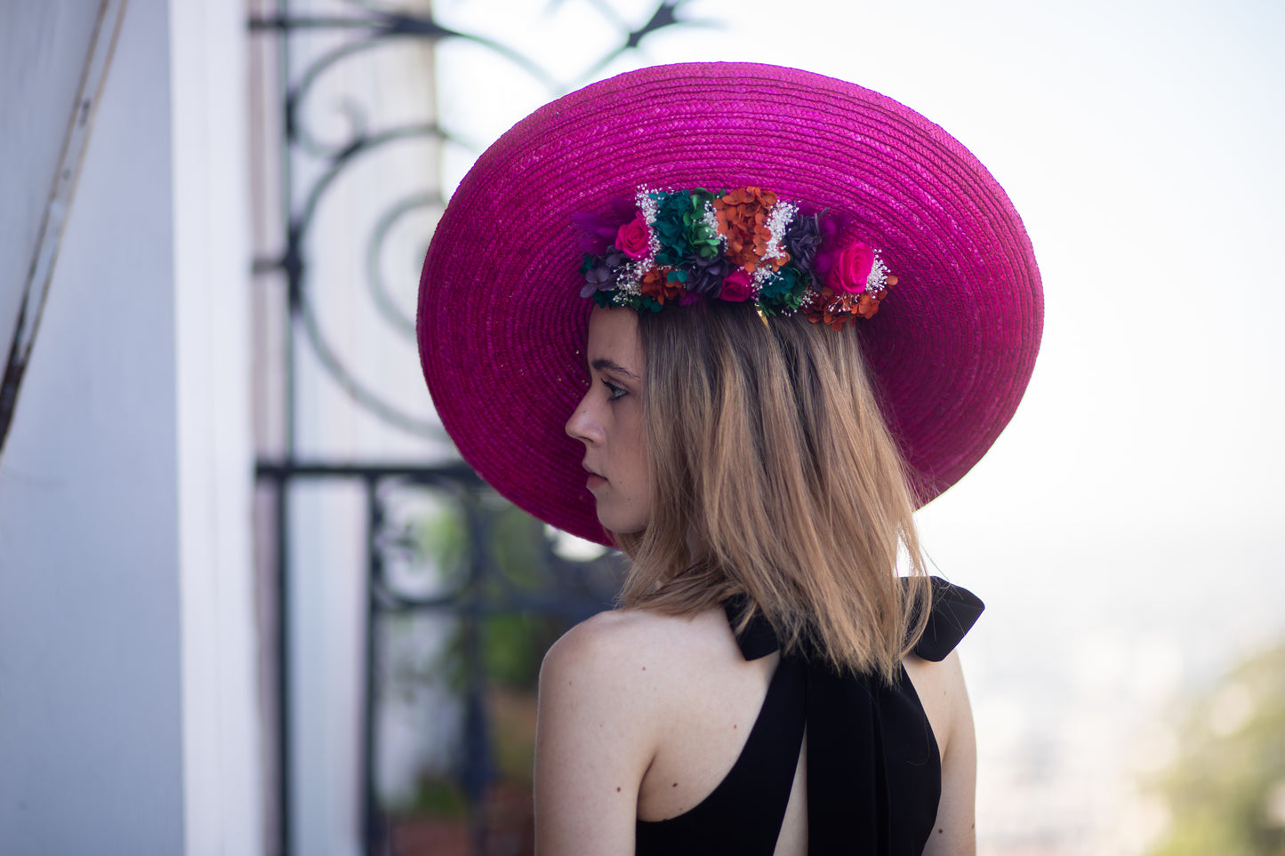 Capeline incurvée en paille colorée décorée de fleurs stabilisées en dessous